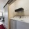 Laundry room with washer, dryer, and storage